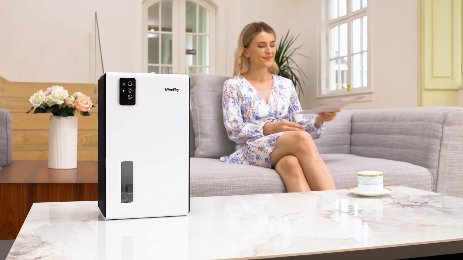 A white NineSky CT2 on a coffee table in a bright living room